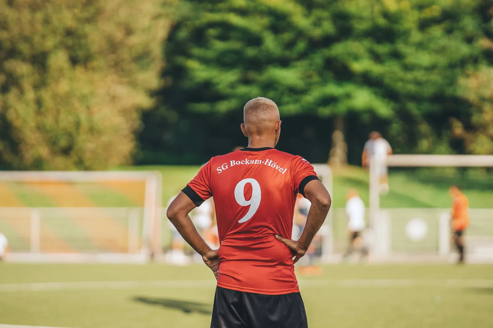 Deportista de espaldas en un campo de fútbol